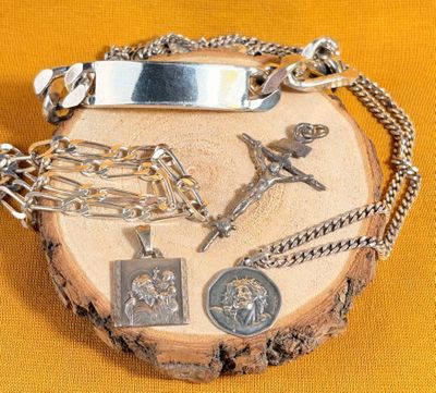 a silver plate with a cross and other religious items on it
