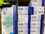 several boxes of gloves are stacked on a shelf in a store