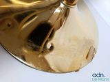 a gold bell sitting on top of a white table