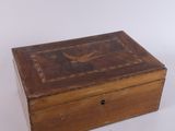 an old wooden box sitting on top of a white surface