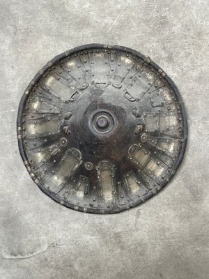 a metal plate with a clock on it on a cement surface