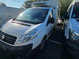 two white vans parked in a parking lot next to each other