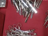 a red table with a bunch of scissors on it