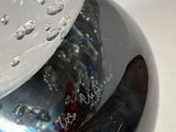 a close up of a glass object with water on it