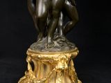 a bronze statue of a man and a woman on a pedestal
