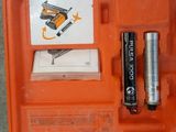 a tool kit in the orange case on the ground