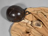 a helmet, goggles, and a pair of pants on the floor