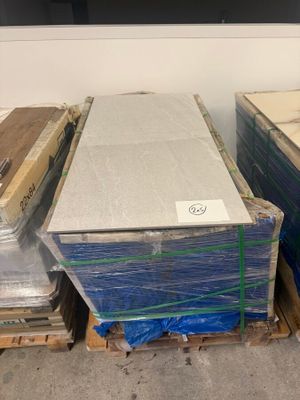 many boxes of mattresses stacked on pallets in a room