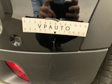 a man taking a picture of himself in the mirror of a car