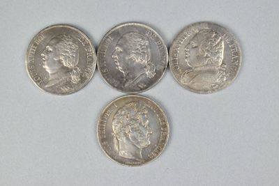 four different types of coins on a white surface