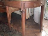 a round table with a marble top on a rug