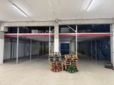 a large warehouse with a lot of pallets in it