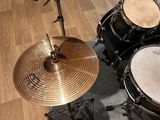 a drum set up on a wooden floor in a room