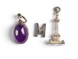 two silver and amethe charms with a purple stone
