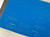 a small blue book sitting on top of a white table