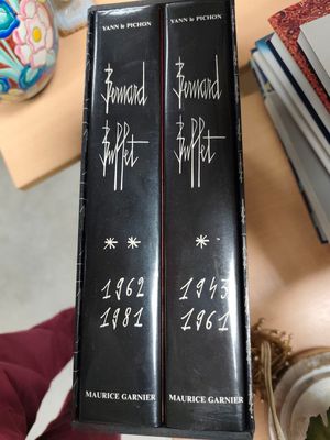 two books sitting on top of a table next to each other