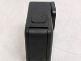 a close up of a small black camera on a table
