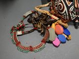 a purse and some beads on a table