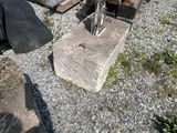 a pile of wood sitting on the ground next to a pile of logs