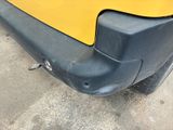 a close up of the bumper of a yellow car