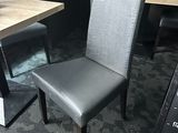 two chairs and a table in the corner of a restaurant