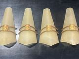 six serviettes blanches ornées d'anneaux dorés, posées sur une table