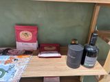 a shelf with a bottle of wine, a bag of coffee, and a bottle of wine on it