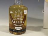 a bottle of alcohol sitting on a table next to a knife