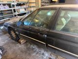a car that is parked in a garage with snow on the ground