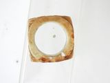 a piece of bread in a glass container on a table
