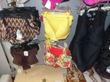 many bags and purses on display in a store