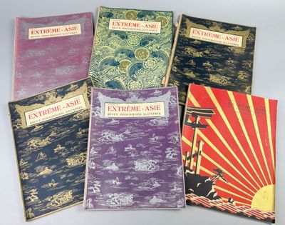 five books of various styles and colors are lined up on a table