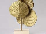 brass leaf table lamp with a white base and a gold shade