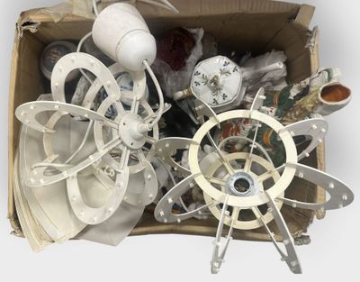 a cardboard box filled with assorted items on a white surface