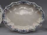 three blue and white plates with floral designs on them sitting on a table