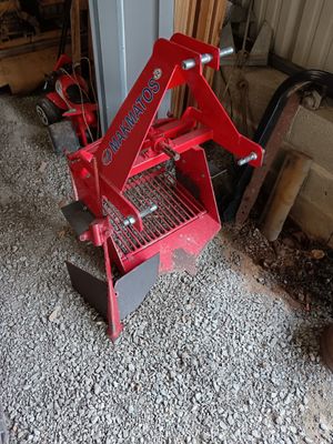 a small red machine that is sitting on the ground