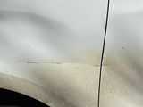 a white car with a sticker on the side of it