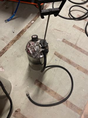 a picture of a canister with a hose attached to it