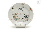 a white plate with a bird and flowers design on it
