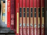 many books that are on a shelf in a book case
