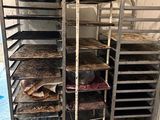 many trays of food that are sitting on a cart