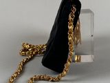 a black purse with a gold chain hanging from it
