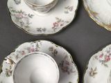 three cups and saucers are sitting on top of a table