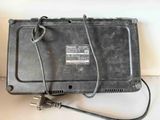 a black box with a power cord attached to it