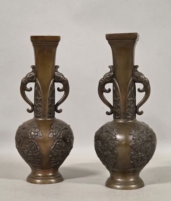pair of antique bronze vases on a white background