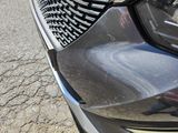 a close up view of a car ' s front bumper with tire treads on it