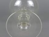 underside view of a wine glass on a grey background
