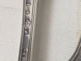 two spoons and a fork sitting on a table