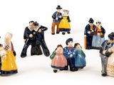 many figurines of people that are standing in a circle