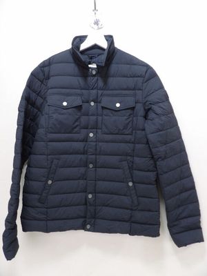 the jacket is hanging on a hanger on the wall